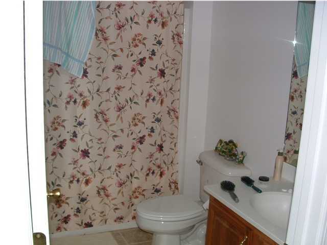 893 Lighthouse Church Road Holt, FL 32564 - Photo 17 of 24 a bathroom with a toilet and a shower curtain