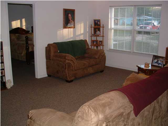 893 Lighthouse Church Road Holt, FL 32564 - Photo 18 of 24 a living room with furniture and a window
