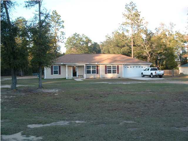 893 Lighthouse Church Road Holt, FL 32564 - Photo 3 of 24 a front view of a house with a yard
