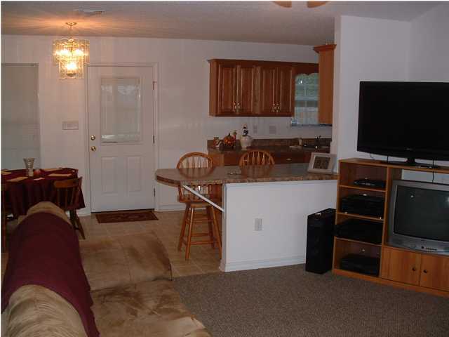 893 Lighthouse Church Road Holt, FL 32564 - Photo 24 of 24 a kitchen with stainless steel appliances kitchen island granite countertop a refrigerator and a stove top oven