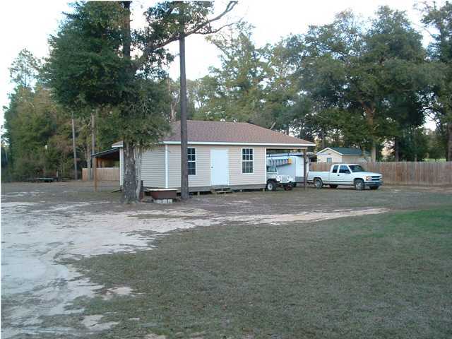893 Lighthouse Church Road Holt, FL 32564 - Photo 6 of 24 a car parked in front of a house