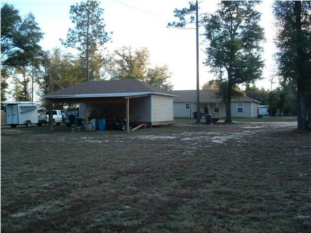 893 Lighthouse Church Road Holt, FL 32564 - Photo 10 of 24 a view of a house with a yard