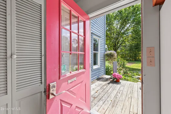 a kitchen with stainless steel appliances a stove a refrigerator sink and wooden floor
