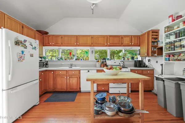 a kitchen with stainless steel appliances granite countertop a refrigerator and a stove top oven