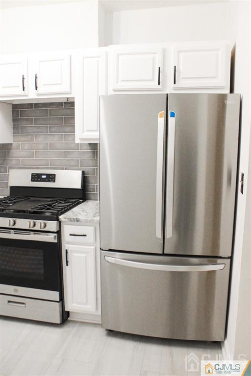 a close view of a refrigerator in kitchen and stainless steel appliances