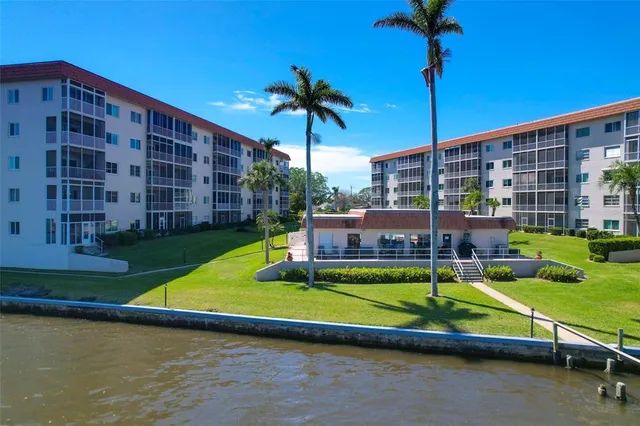 a view of a swimming pool with a yard and deck