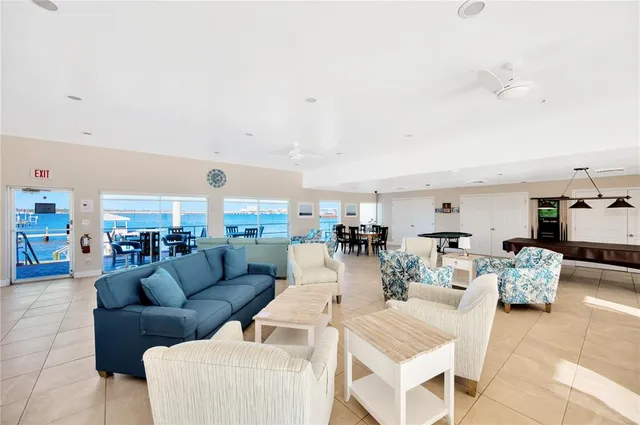 a living room with furniture and a view of kitchen