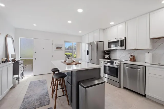 a kitchen with cabinets and stainless steel appliances