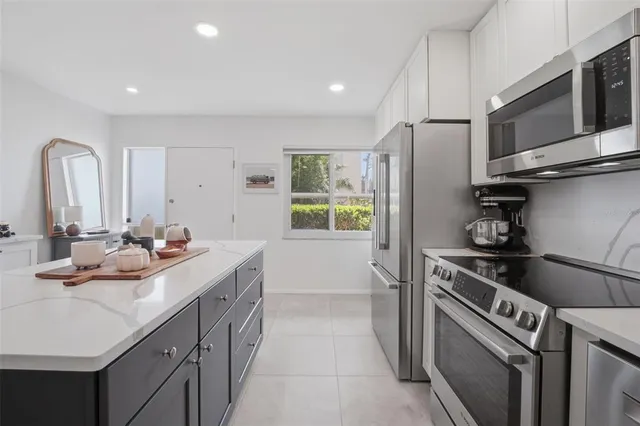 a kitchen with a sink stove and refrigerator