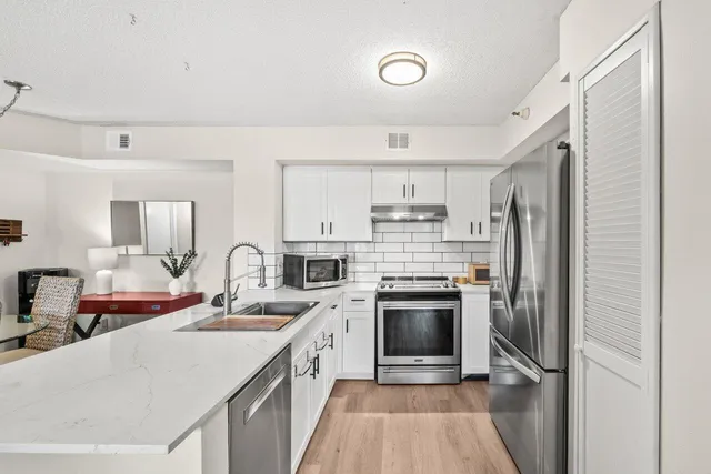 a kitchen with a sink stove and refrigerator