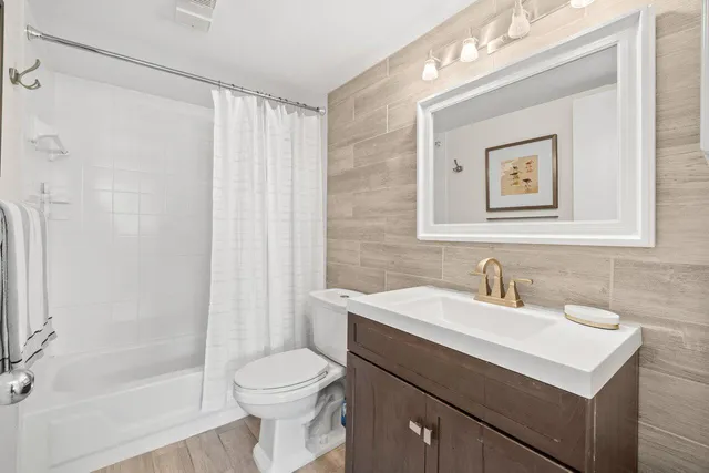 a bathroom with a sink toilet and shower