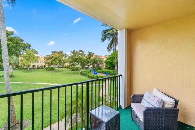 a view of a chair and tables in the balcony