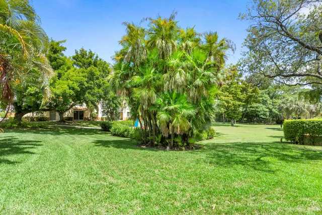 a view of yard with swimming pool and green space