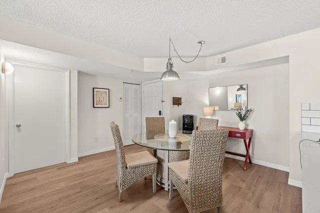 a view of a dining room with furniture and wooden floor