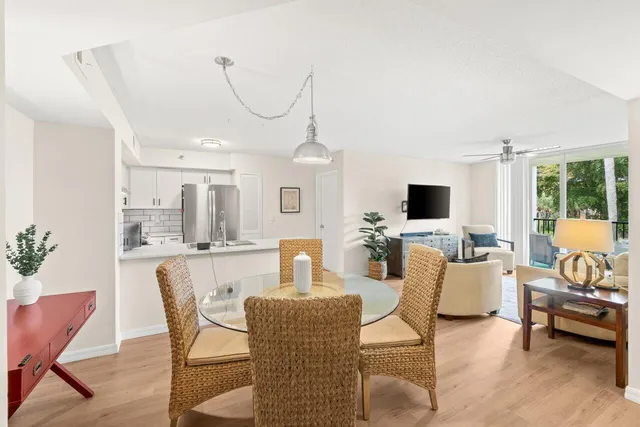 a living room with furniture a flat screen tv and a large window