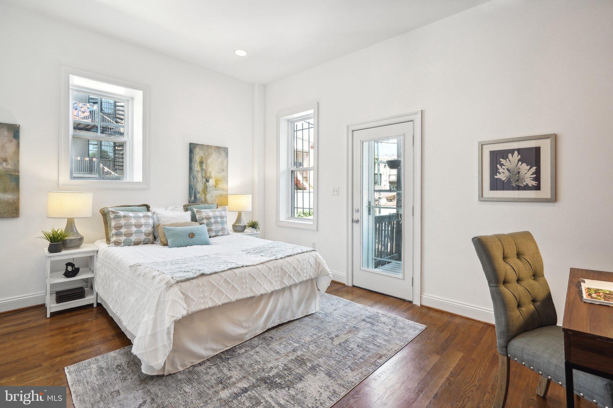 77 U Street Northwest Washington, DC 20001 - Photo 12 of 34 a bedroom with a large bed a rug and a window