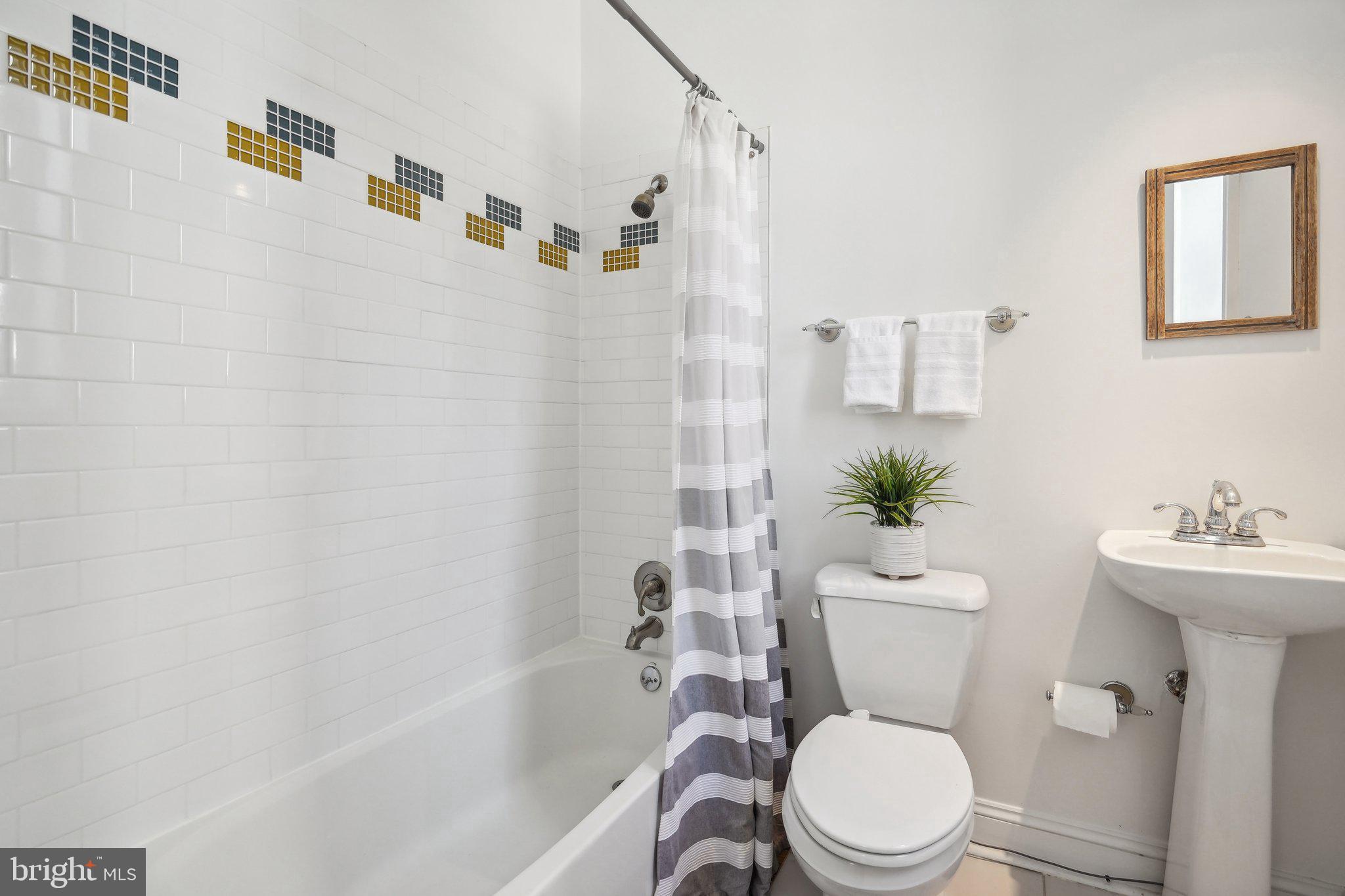 77 U Street Northwest Washington, DC 20001 - Photo 15 of 34 a white toilet sitting next to a bathroom sink