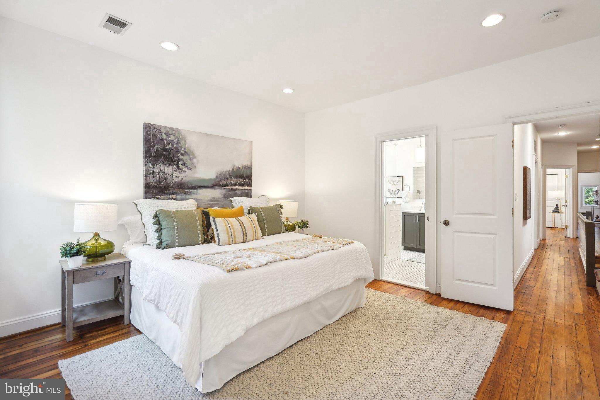77 U Street Northwest Washington, DC 20001 - Photo 18 of 34 a bedroom with a bed and wooden floor