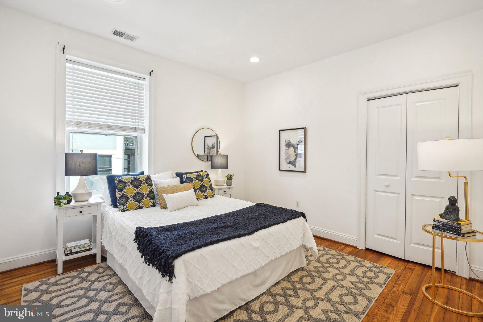77 U Street Northwest Washington, DC 20001 - Photo 21 of 34 a bedroom with a large bed and a window