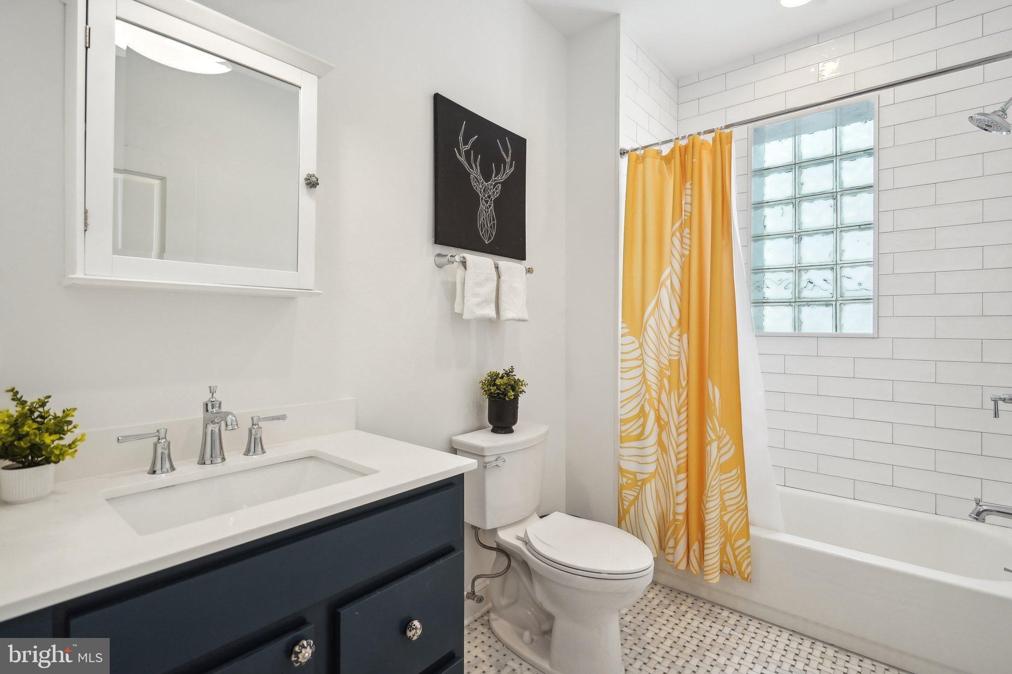 77 U Street Northwest Washington, DC 20001 - Photo 22 of 34 a bathroom with a sink a toilet and shower