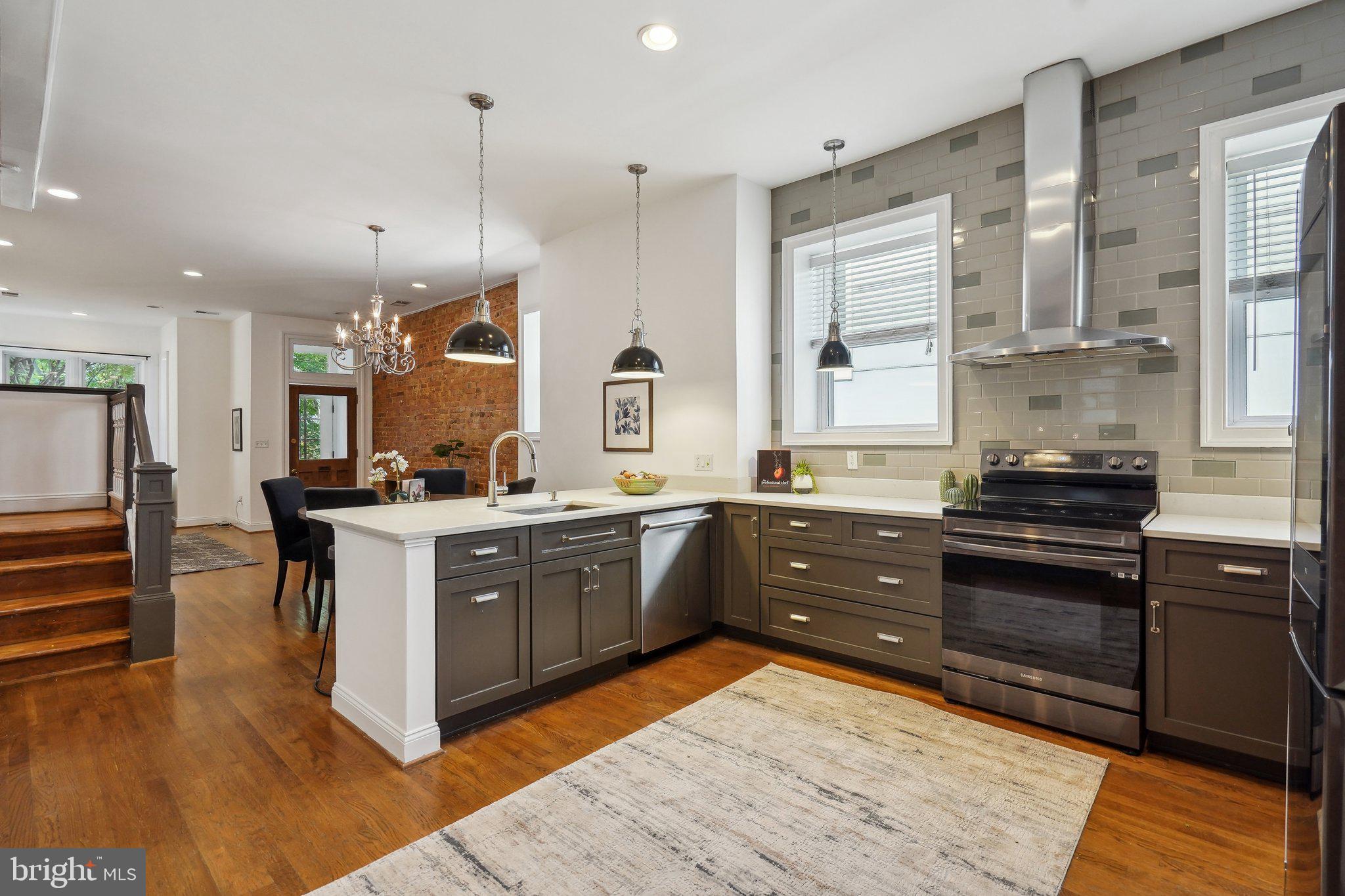 77 U Street Northwest Washington, DC 20001 - Photo 7 of 34 a large kitchen with stainless steel appliances granite countertop a stove a sink dishwasher and a refrigerator