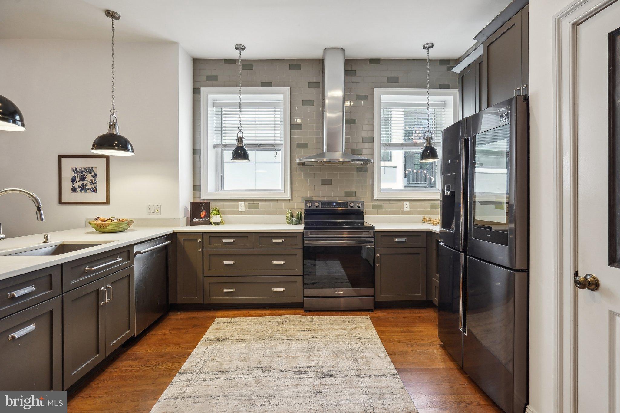77 U Street Northwest Washington, DC 20001 - Photo 8 of 34 a kitchen with a refrigerator and a sink