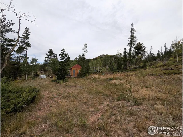 a view of a backyard with sitting area