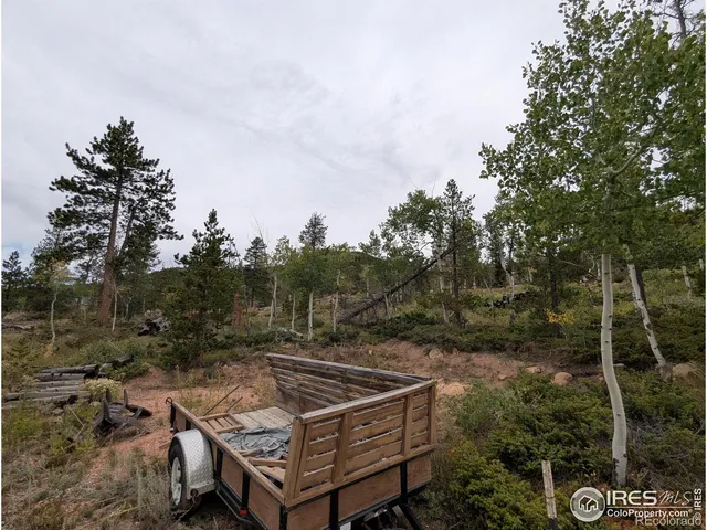 a view of a house with large wooden deck and a backyard