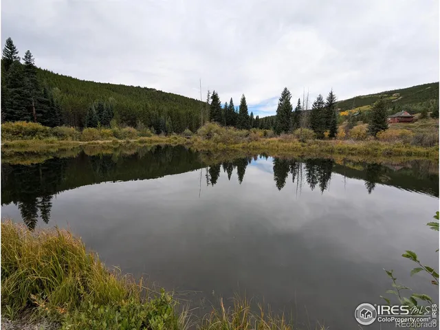 a view of a yard with wooden fence