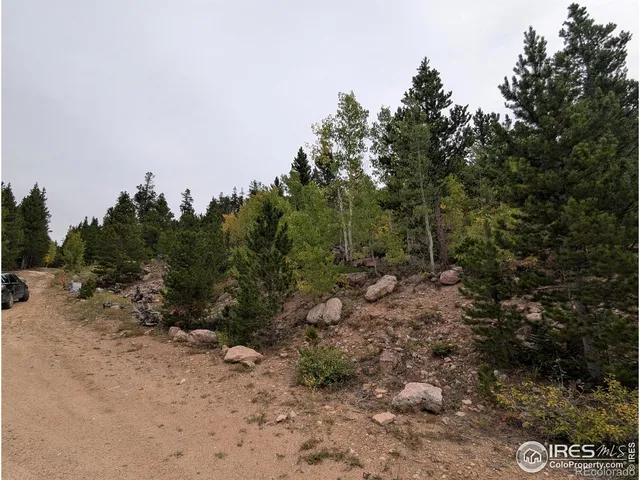 a view of a town with couple of cars parked