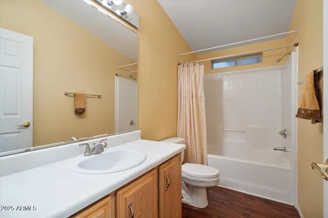 a view of a kitchen with wooden floor and cabinets