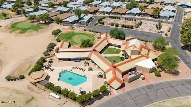 an aerial view of a house with a yard and lake view