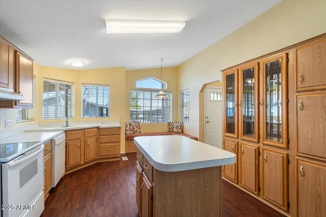 a kitchen with a sink stove and cabinets