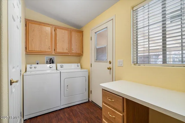 a large kitchen with a large window and stainless steel appliances