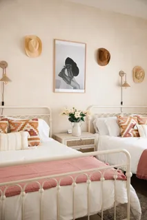a bedroom with a bed and painting on the wall