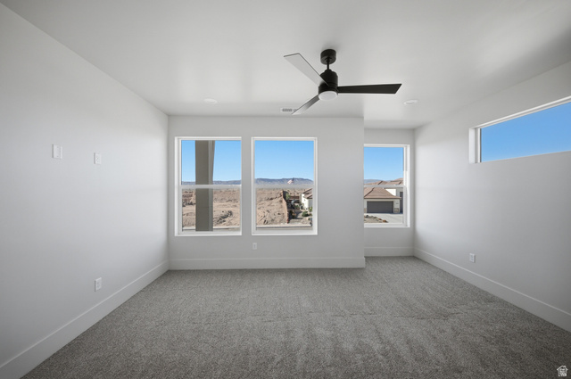 3011 East Rimrunner Drive, Unit 302 St. George, UT 84790 - Photo 36 of 45 Empty room featuring carpet floors, ceiling fan, and plenty of natural light