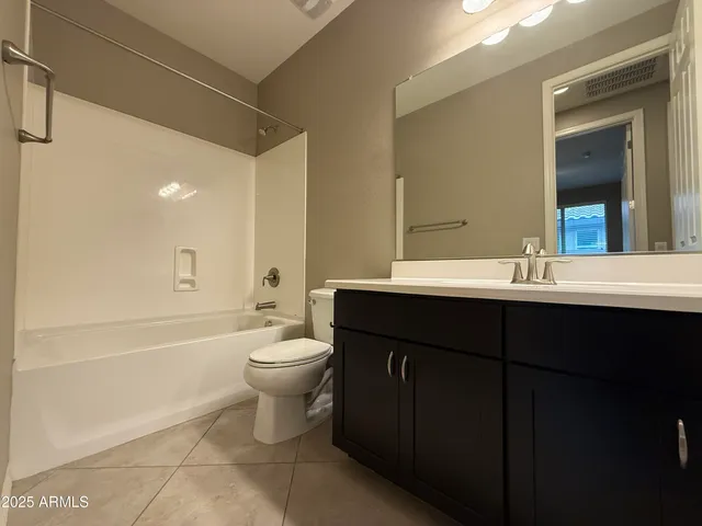 an empty room with a ceiling fan and a window