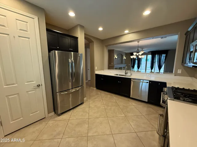 a view of a livingroom with a furniture wooden floor and chandelier