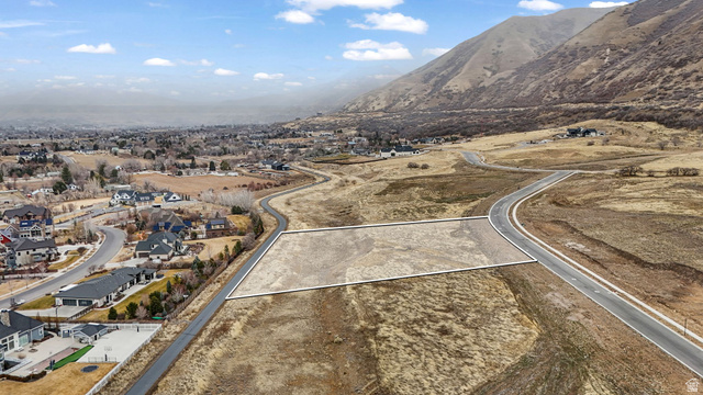 2116 South Valley View Drive, Unit 58 Mapleton, UT 84664 - Photo 3 of 13 Aerial perspective of suburban area featuring a mountainous background and property boundaries highlighted