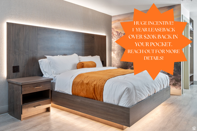 Wood-finish flooring with a floating bed frame featuring under-bed lighting
