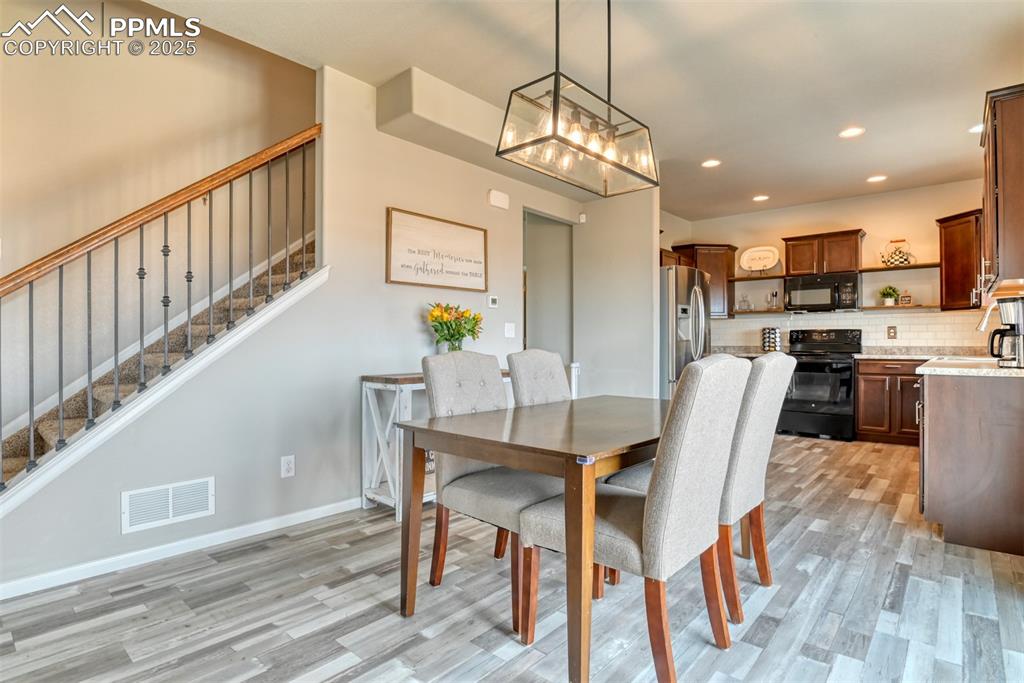 Undisclosed Address Peyton, CO 80831 - Photo 12 of 50 a view of a dining room with furniture a chandelier and wooden floor
