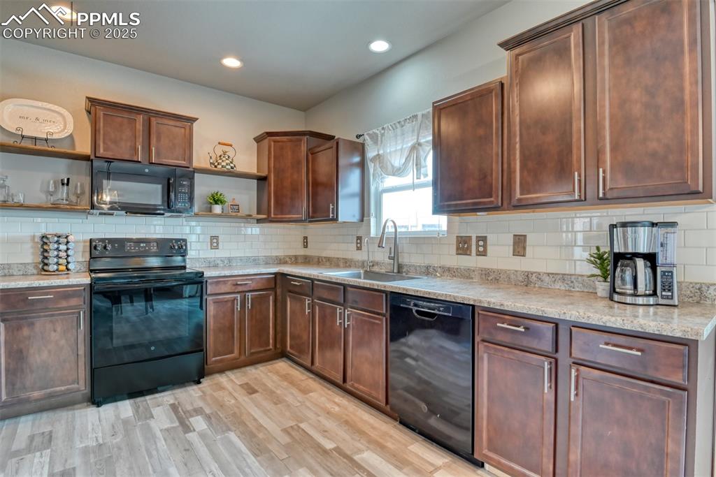 Undisclosed Address Peyton, CO 80831 - Photo 16 of 50 a kitchen with stainless steel appliances granite countertop wooden cabinets a sink and dishwasher