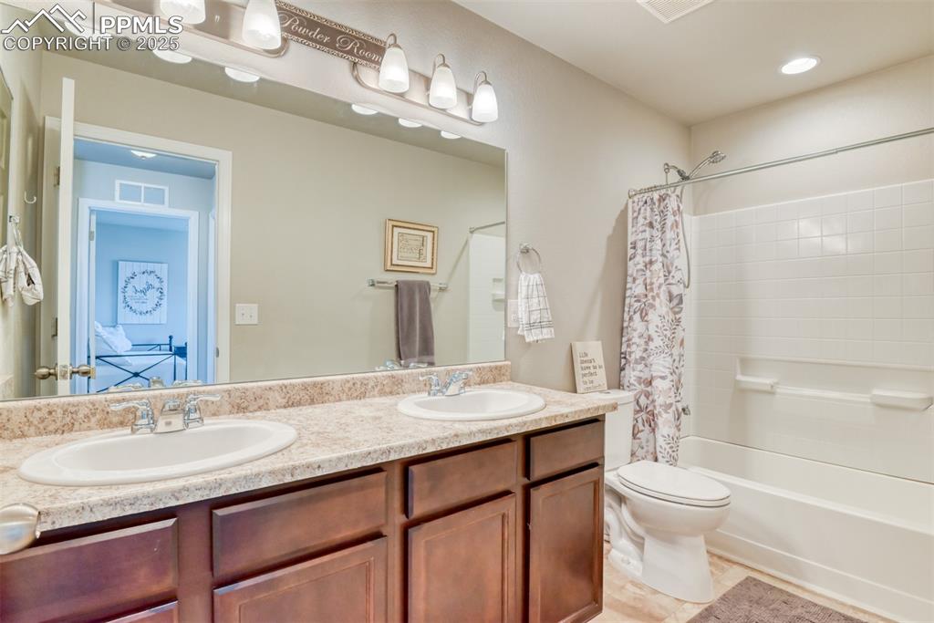 Undisclosed Address Peyton, CO 80831 - Photo 19 of 50 a bathroom with a granite countertop sink toilet a large mirror a shower and a bathtub