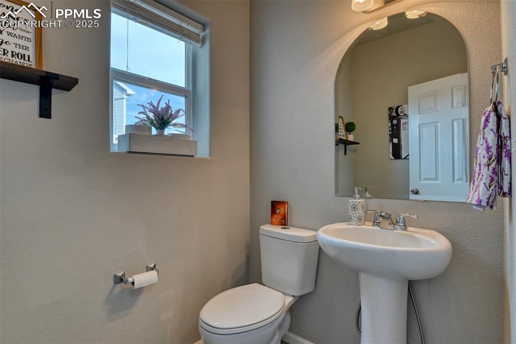 Undisclosed Address Peyton, CO 80831 - Photo 20 of 50 a bathroom with a toilet a sink and mirror