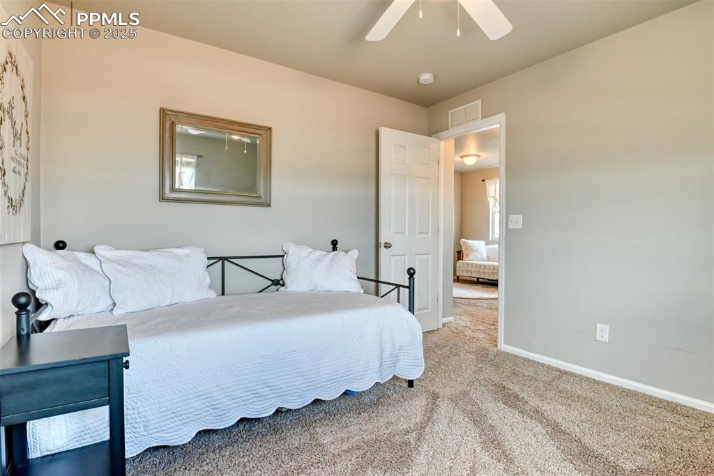 Undisclosed Address Peyton, CO 80831 - Photo 39 of 50 a spacious bedroom with a bed and a chandelier