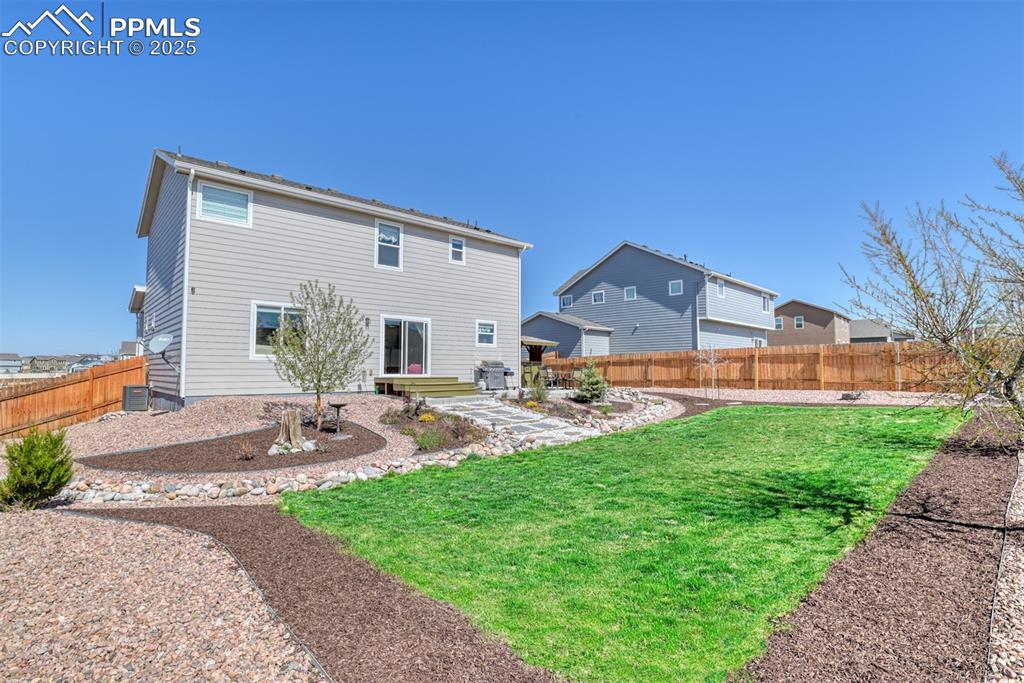 Undisclosed Address Peyton, CO 80831 - Photo 43 of 50 a front view of a house with garden and sitting area