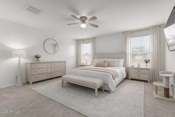 a bedroom with a bed and a chandelier