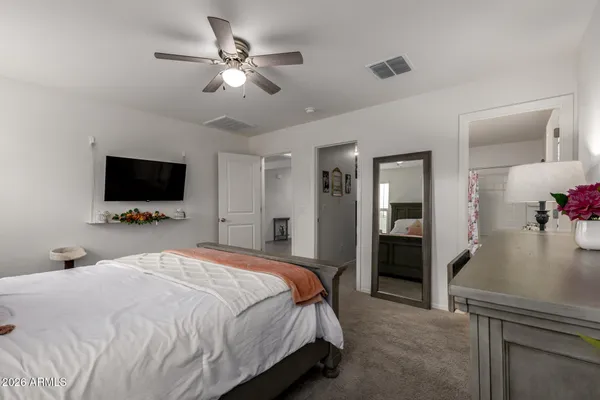 a bedroom with a bed and a flat screen tv