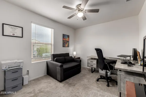 a livingroom with workspace couch and a window