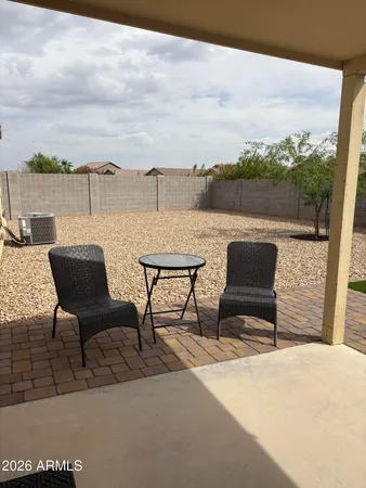 a view of a terrace with furniture and city view